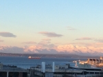 the morning sun touches the Olympic mountains